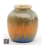 A small Ruskin Pottery vase decorated in a crystalline glaze with blue flecks over a tonal orange to
