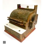 An early 20th Century brass National cash register No F 730152 349-SH, lacking glass top, width 42cm