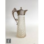 A hallmarked silver and clear glass claret jug, the diamond cut glass body below silver collar and