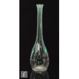 A clear glass bottle form vase in the manner of Stuart and Sons, with applied green peacock trail