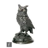 A 19th Century spelter inkwell in the form of an owl with hinged lid and glass eyes standing to a