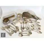 A small parcel lot of assorted silver to include a cream and sugar, sauce boat, flatware and a