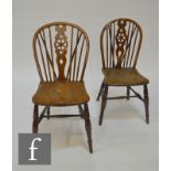 Two 19th Century country wheelback chairs of ash, elm and beech construction, with solid seat panels