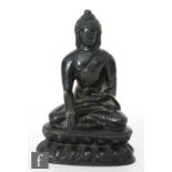 A 19th/20th Century Sino-Tibetan patinated bronze figure of Shakyamuni Buddha, seated in vajrasana