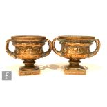 A pair of 20th Century miniature brass models of the Warwick vases each on square plinth bases,