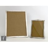 Two hallmarked silver easel photograph frames of plain form, heights 22cm and 15cm, both