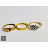 A 22ct wedding ring, weight 3g, with an 18ct five stone ring weight 2.4g and a 9ct diamond ring,