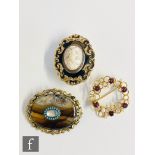 Three assorted brooches to include a 9ct garnet and pearl, a memorial and a banded agate example. (