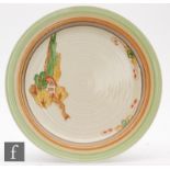 A Clarice Cliff plate decorated in the Elizabethan Cottage pattern with a small cartouche within