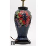 A Moorcroft Pottery table lamp decorated in the Anemone pattern, marks obscured by affixed base,