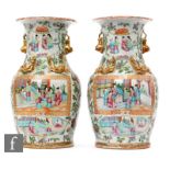 A pair of 19th Century Chinese Canton famille rose vases, each of ovoid form, rising to an everted