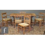 A 20th Century set of six oak and beech framed dining chairs, with castellated top rails and