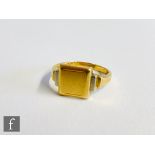 An 18ct yellow and white gold signet ring, engine turned decoration to square head and stepped
