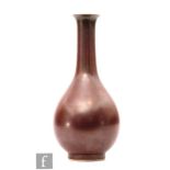 A Chinese 'iron-rust' glazed vase, of bottle form extending to a flared rim, with allover lustrous