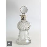 A hallmarked silver and clear cut glass decanter modelled as a thistle, the glass body rising to