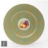 A Royal Worcester cabinet plate decorated by Christopher Hughes with a small Fallen Fruits roundel