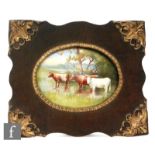 A framed Doulton Burslem oval plaque decorated by H. Marrey with cows in a boggy landscape,