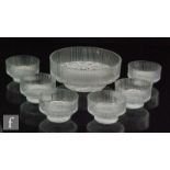 A later 20th Century footed glass bowl with six smaller bowls, all with moulded textured