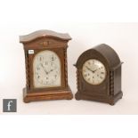 A 1920s oak cased mantle clock the silvered arch dial incorporating two subsidiary dials striking on