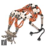 An Afghanistan five row necklet comprising coral, shell and white metal bells, length 86cm.