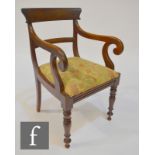 A 19th Century mahogany carver armchair, with yoke back over scroll capitals and turned front