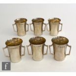 A set of six hallmarked silver three handled shot cups of plain from, heights 4.5cm, Birmingham