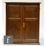 A 19th Century and later oak double door wall cupboard, with fielded door panels, height 95cm, width