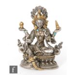 A Sino-Tibetan votive figure of four-armed Avalokiteshvara, raised on a double lotus base, seated in