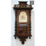 A late 19th Century walnut cased regulator wall clock with circular dial and spring driven