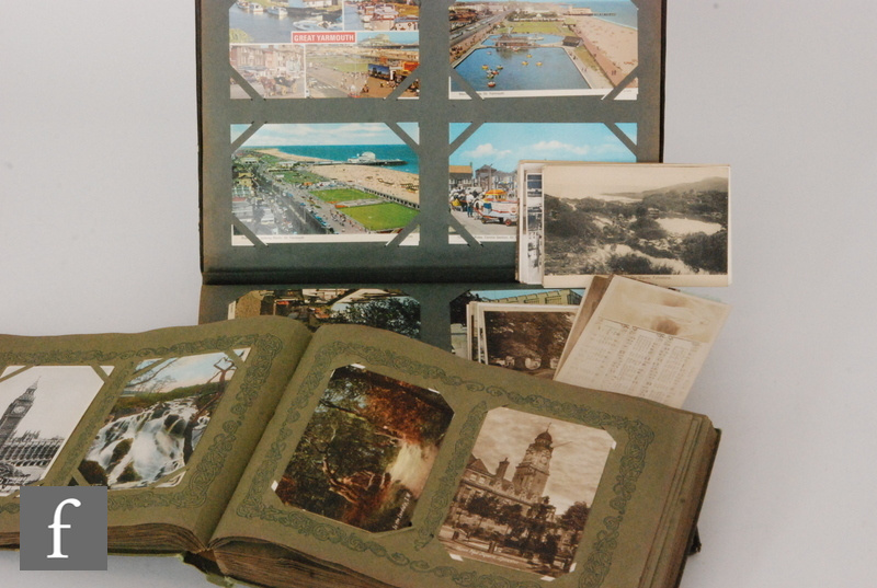 An extensive collection of Edwardian, 1930s and later postcards contained in two albums and a