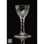 An 18th Century drinking glass circa 1790, ovoid bowl with a band of printie cut circles with