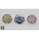 A later 20th Century Strathearn glass paperweight with central ring of millefiori canes,