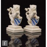 A pair of mid 20th Century Nymphenburg blanc de chine models of Bavarian Lions modelled by Ernst