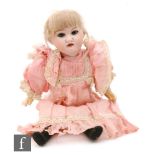 An early 20th Century German bisque head doll by Theodor Recknagel with sleeping eyes, painted