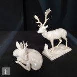 Two 20th Century Nymphenburg blanc de chine models of deer, the first a seated doe, model 424 curled