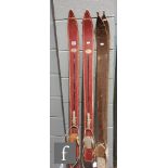 A pair of early 20th Century wooden skis and a pair of red painted wooden skis (4)