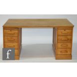 A second quarter 20th Century oak twin pedestal desk of large proportions, fitted with an