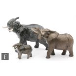 Three Beswick model elephants comprising a 'Trunk stretching' model 998 in satin matt, a 'Trunk in