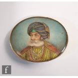 A 19th century miniature on ivory depicting an Indian nobleman, oval, in unmarked yellow metal