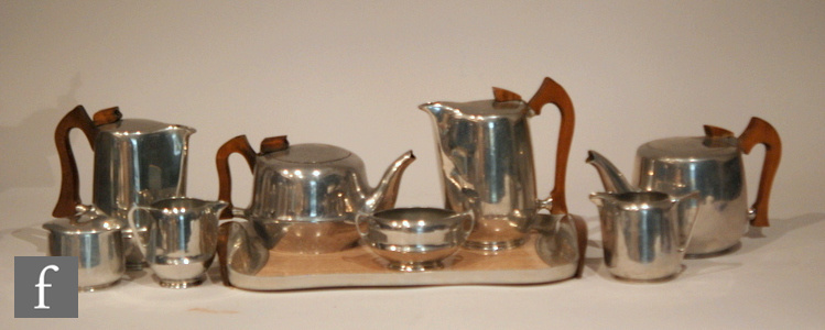 Two 1960s Picquot Ware tea sets, the first comprising teapot, hot water jug, milk, open twin handled