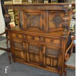 A reproduction carved oak court cupboard in the 17th Century style, with foliate carved detail