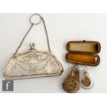 A hallmarked silver lady's evening purse with part engraved swag decoration with a gold mounted