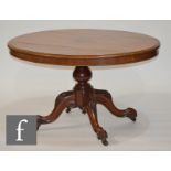 A Victorian walnut oval breakfast or loo table, raised to four outswept carved legs, S/D.