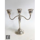 A hallmarked silver three light candelabra of plain form with reeded twin arms, height 23cm,