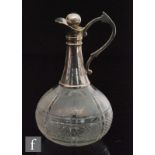 An early 20th Century claret jug, the clear glass of squat form and decorated with panels of diamond