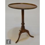 A 19th Century and later mahogany wine table, the later associated circular top over a turned gun