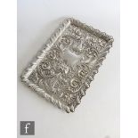 A hallmarked silver rectangular tray with embossed bird and mask detailed within foliate scroll