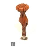 A 19th Century carved wooden desk seal modelled as a hand holding a reeded column above plain