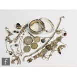 A small parcel lot of assorted silver jewellery to include bangles, chains, earrings coins etc,