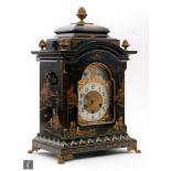 An early 20th Century Chinoiserie black lacquered bracket clock by John Bennett London, the arched